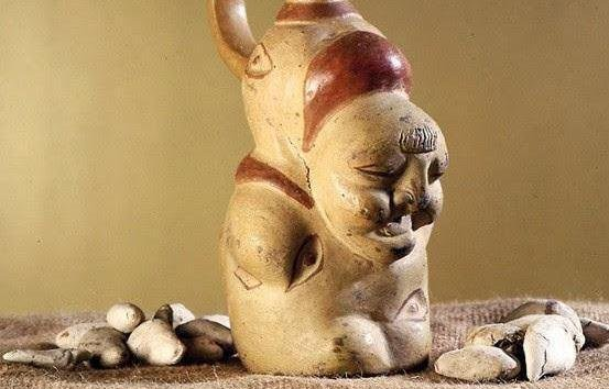 The image shows a potato sculpture of the Incan goddess of potatoes, Axomamma.